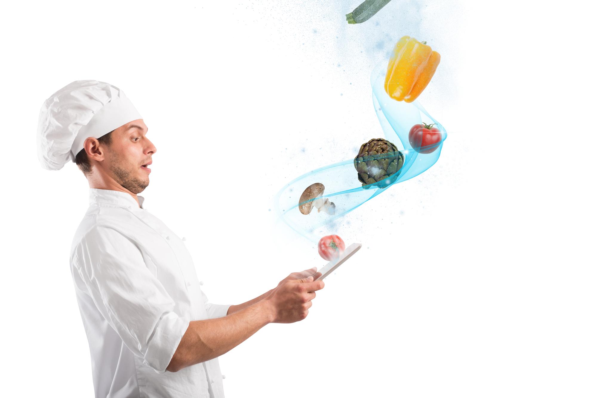 Chef che prepara piatto moderno in cucina tecnologica